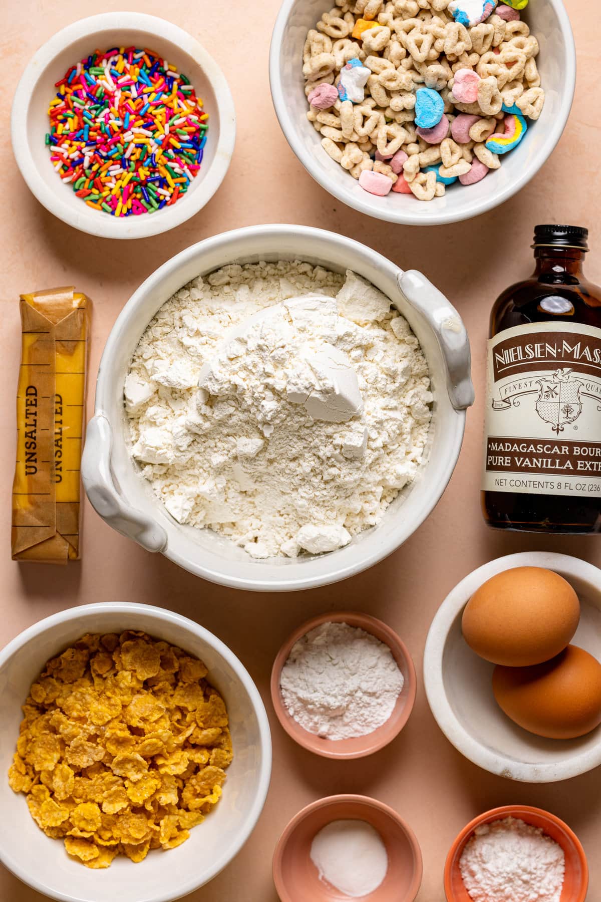 Ingredients for Loaded Lucky Charms Cornflakes Sugar Cookies including vanilla extract, eggs, butter, and sprinkles