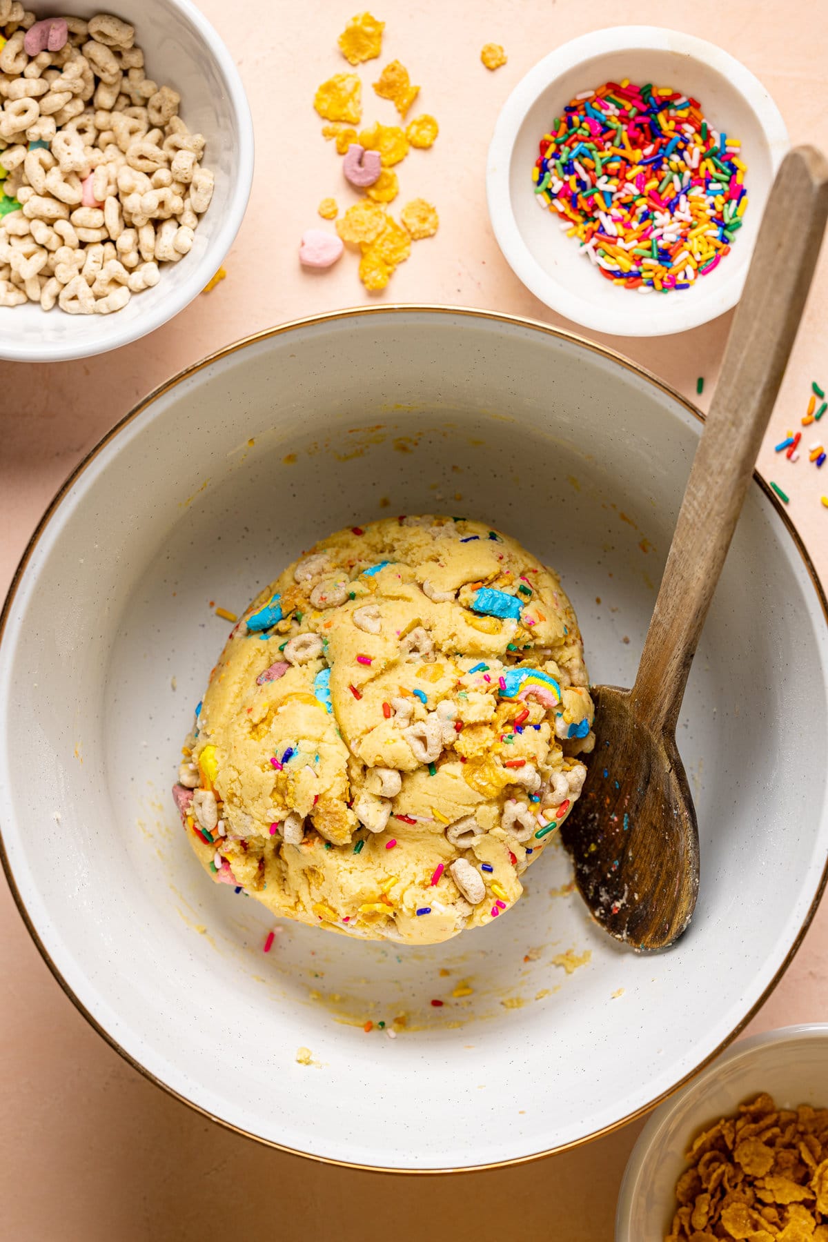 Bowl of Loaded Lucky Charms Cornflakes Sugar Cookie dough with a spoon