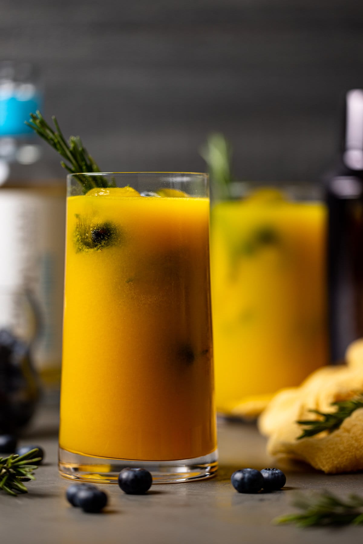 Glass of Mango Lemonade Kombucha Mocktail with rosemary