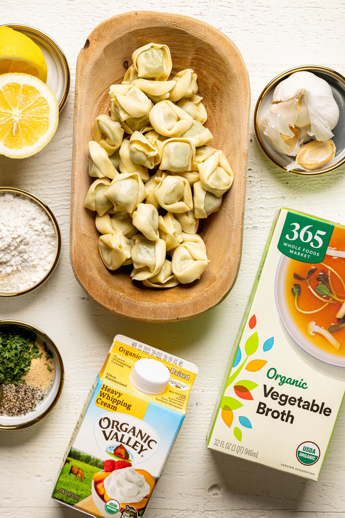 Ingredients for Creamy Lemon Broccoli Tortellini Soup including vegetable broth, garlic, heavy whipping cream, and tortellini