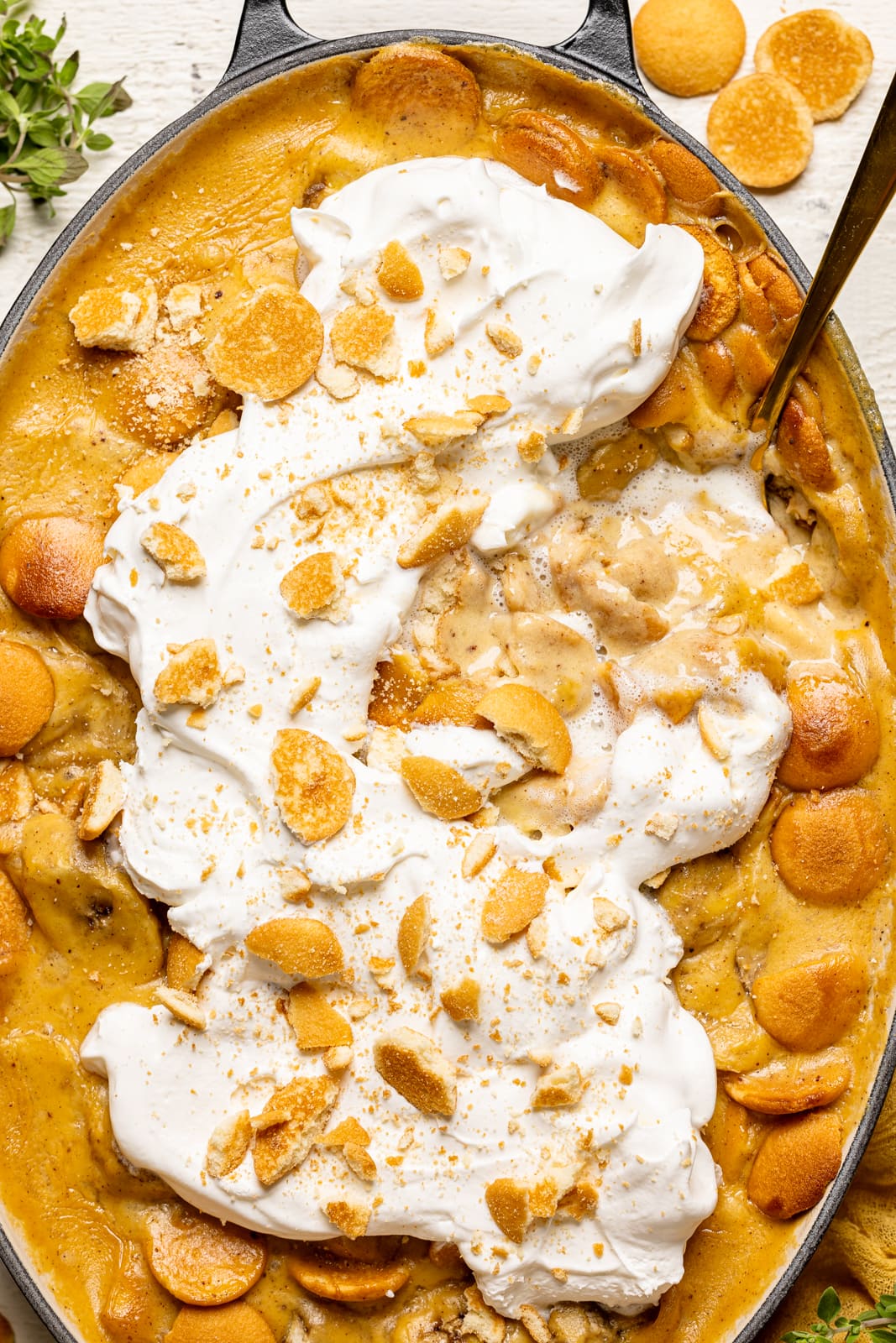 Overhead image of baked banana pudding with a spoon.