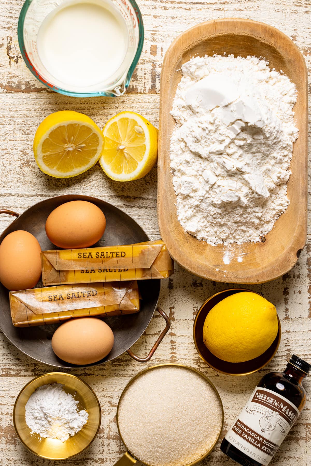 Ingredients for Iced Lemon Loaf Pound Cake including eggs, lemons, vanilla, and butter