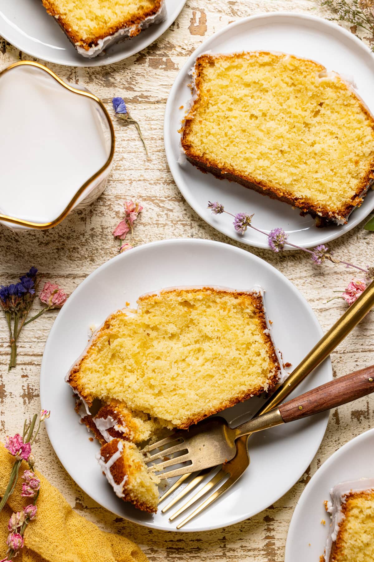 Two slices of Iced Lemon Loaf Pound Cake on plates