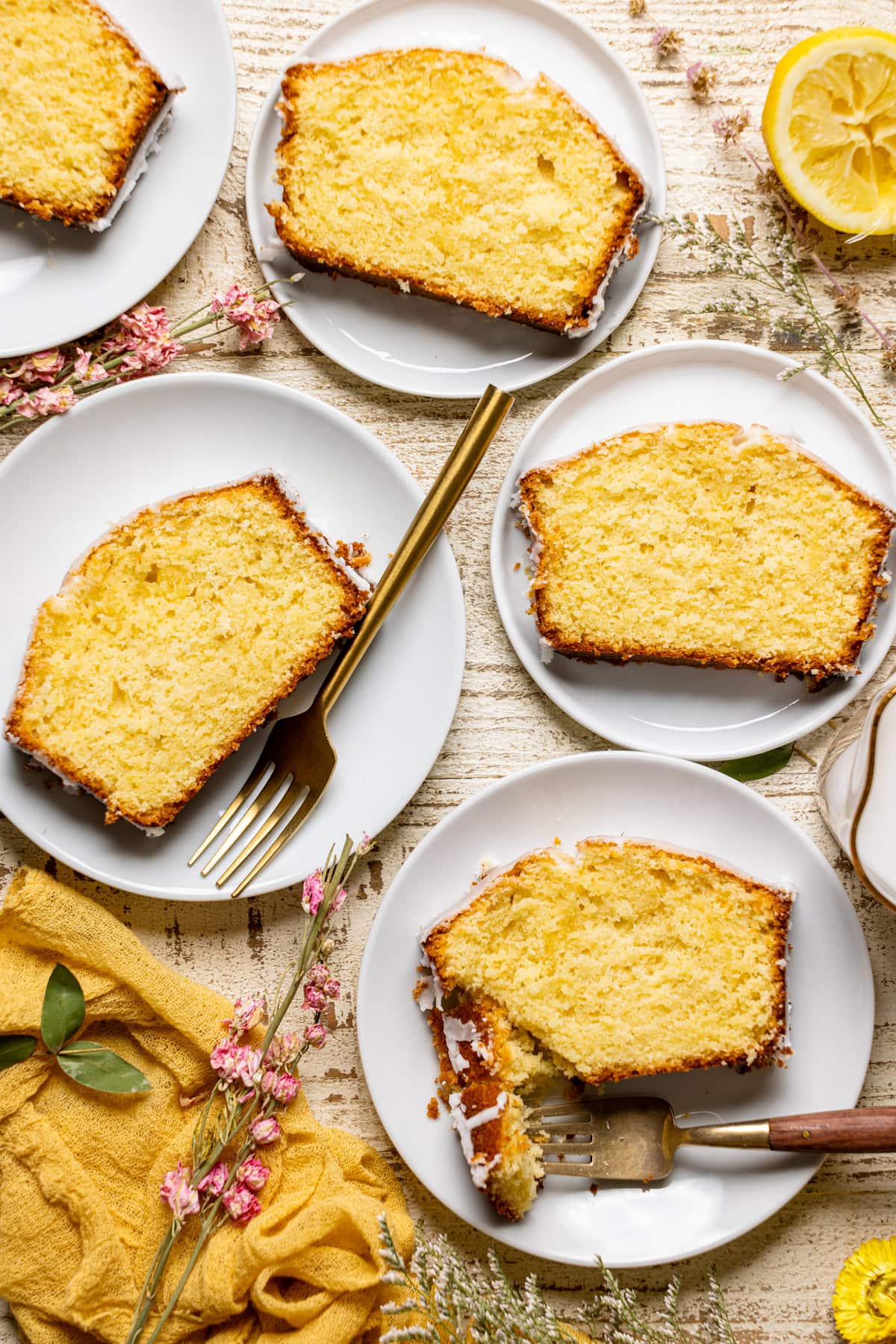 Overhead shot of slices of Iced Lemon Loaf Pound Cake on plates