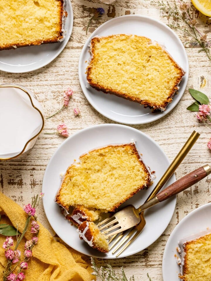 Slices of Lemon Loaf Pound Cake with Icing on plates with forks