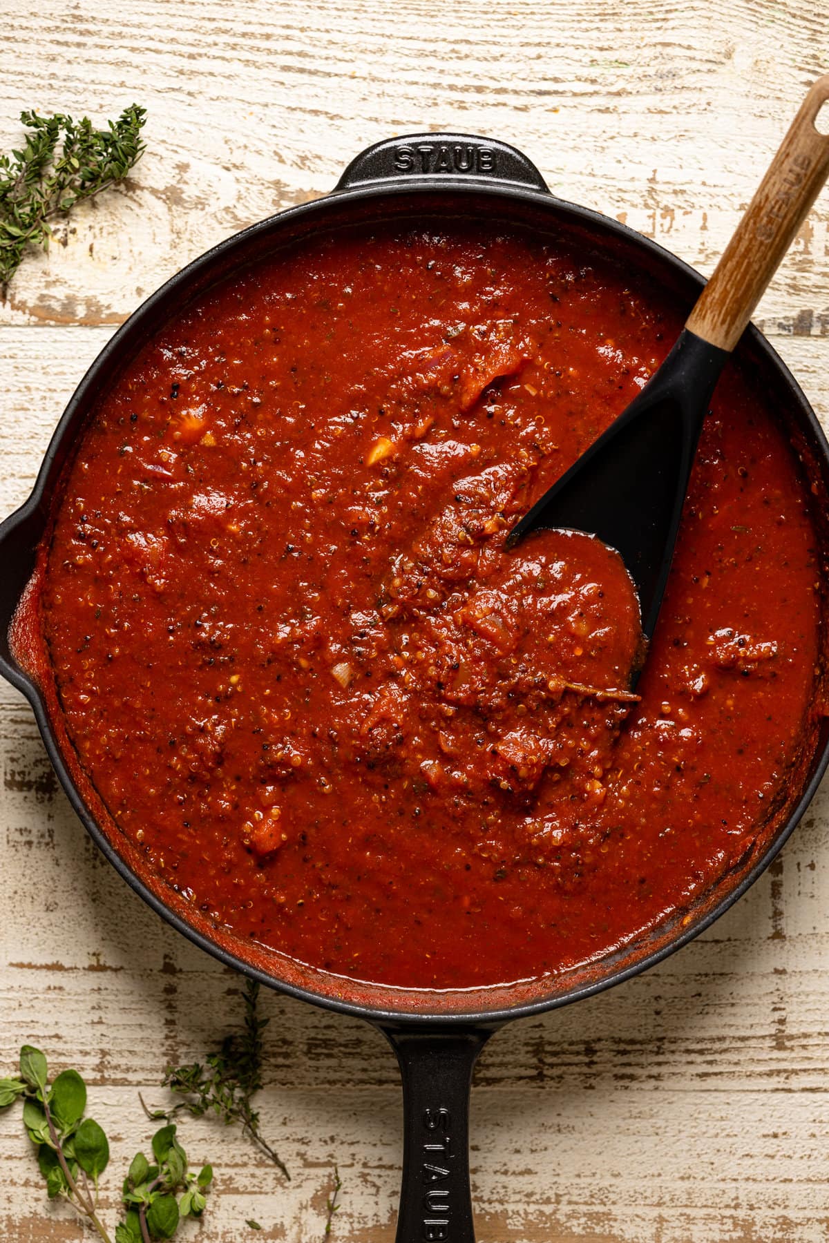 Spoon stirring Vegan Meat Sauce in a pan