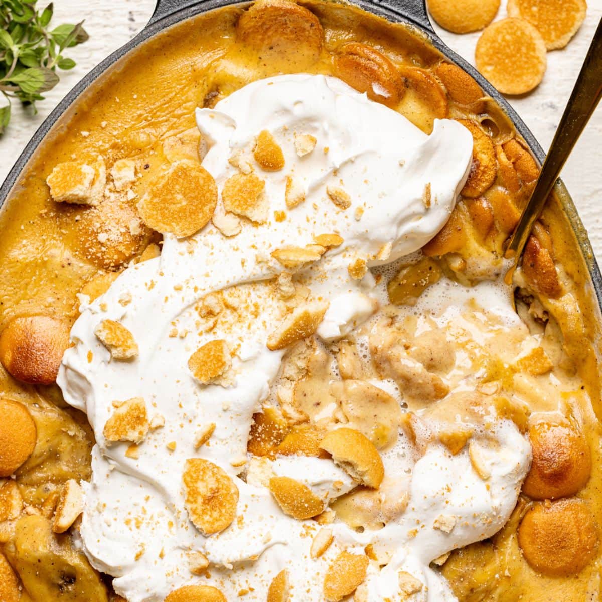 Overhead image of baked banana pudding with a spoon. A classic southern soul food.