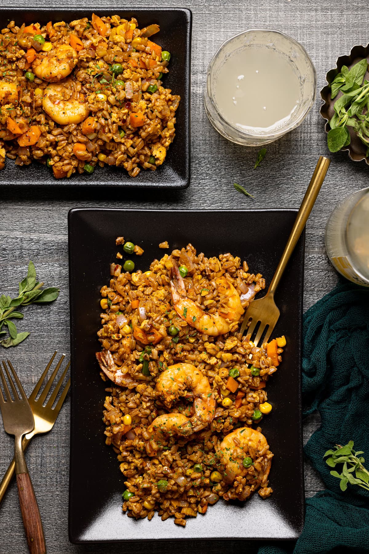 Overhead shot of Healthy Weeknight Shrimp Fried Rice on a black, rectangular plate