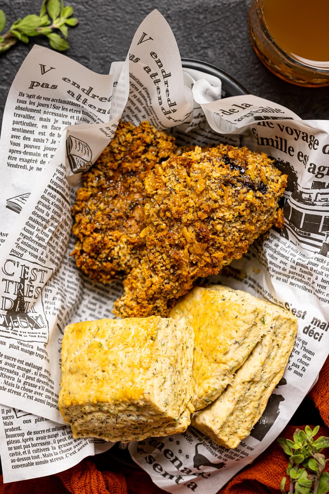 A food basket with chicken and biscuits.