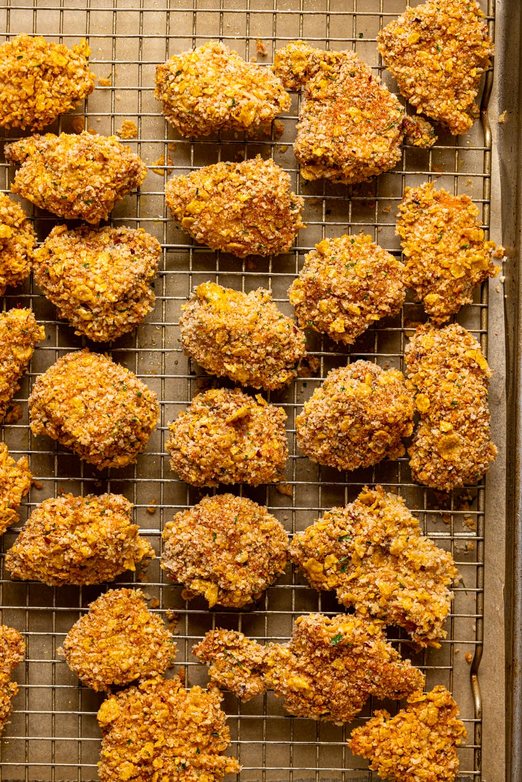 Baked popcorn chicken on a wire rack.