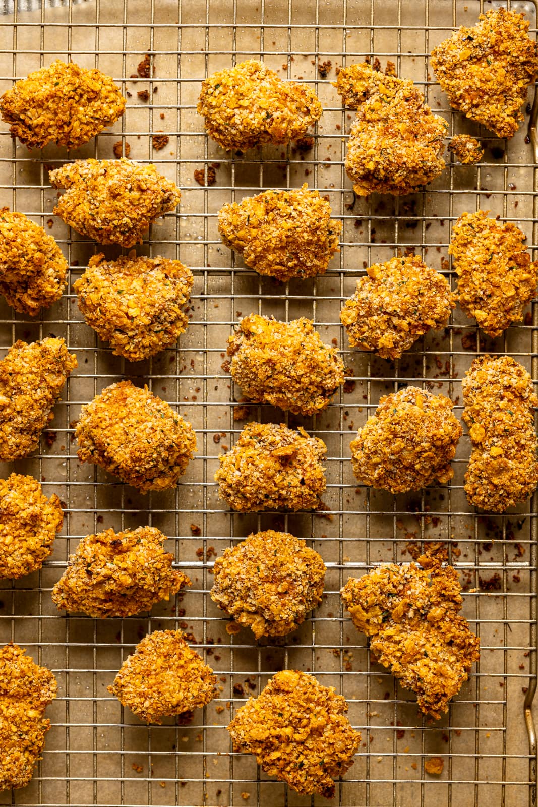 Baked popcorn chicken on a wire rack.