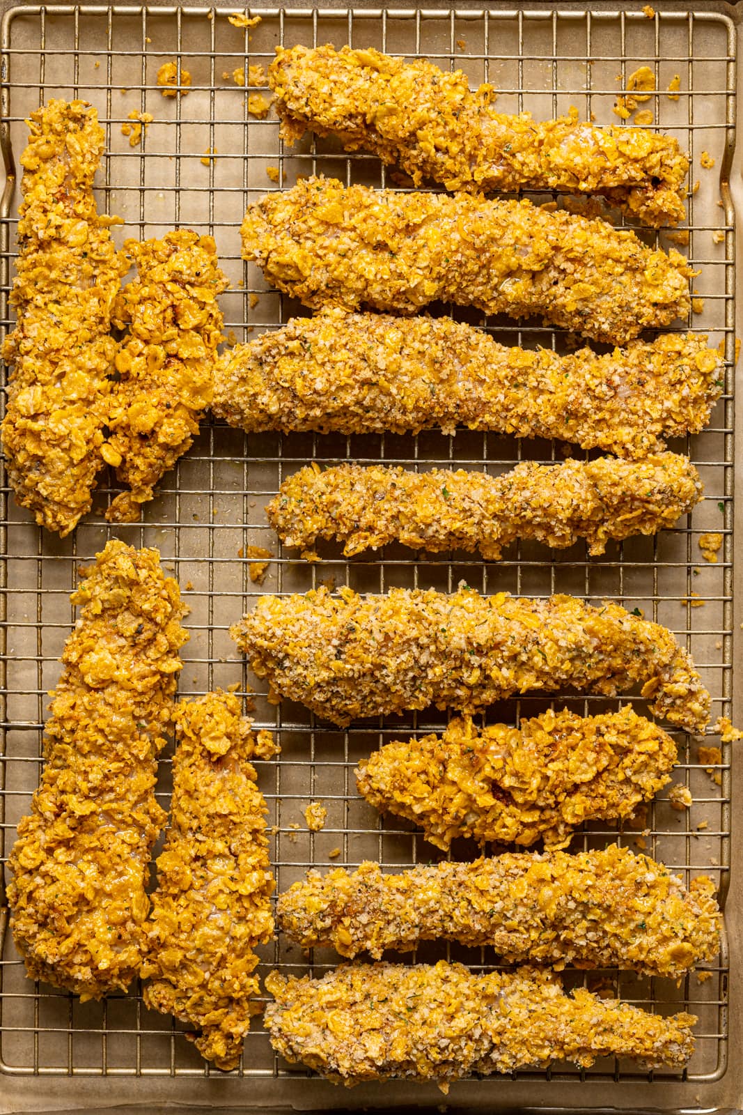 Chicken tenders on a baking sheet with a wire rack.