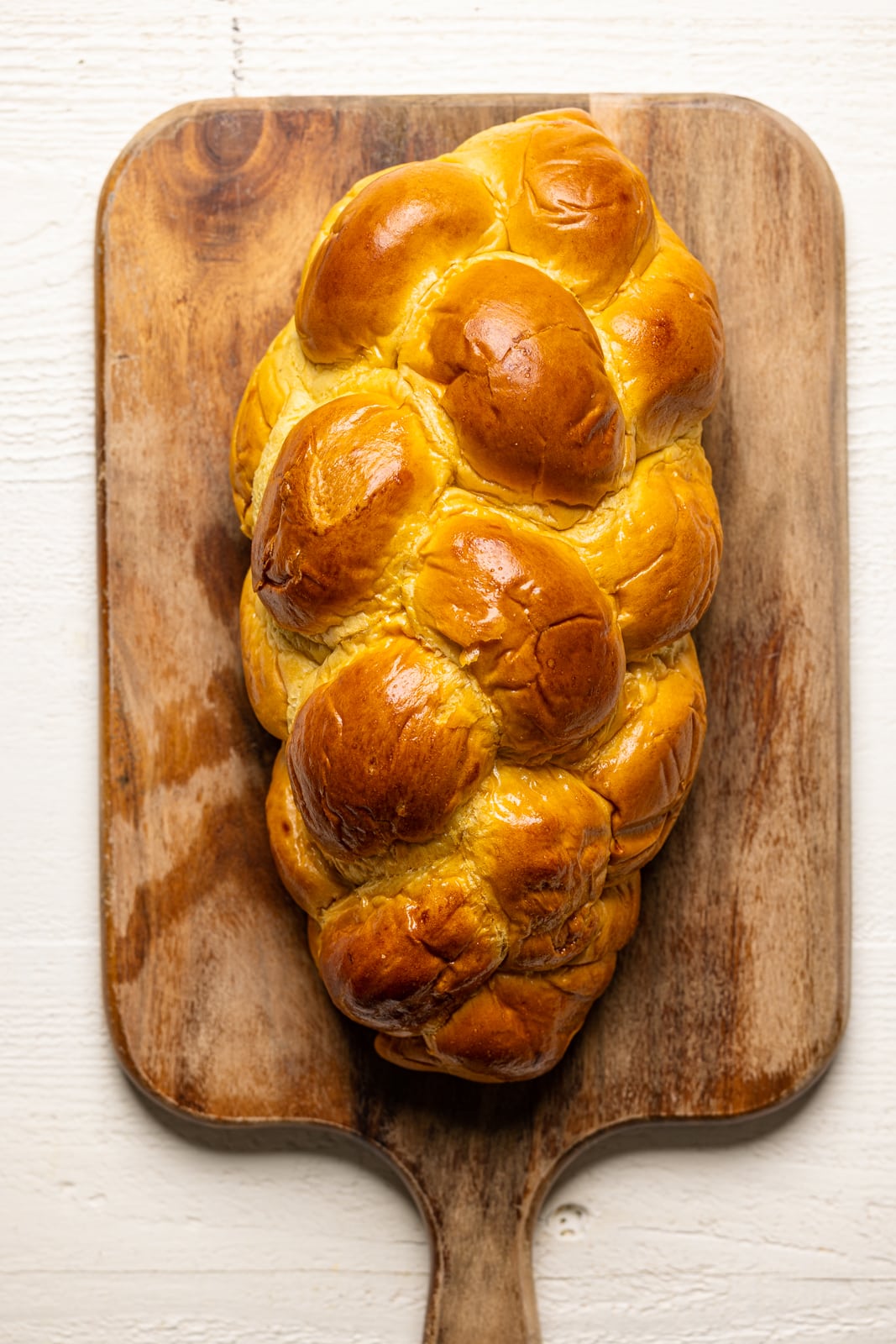 Loaf of braided bread on a cutting board.