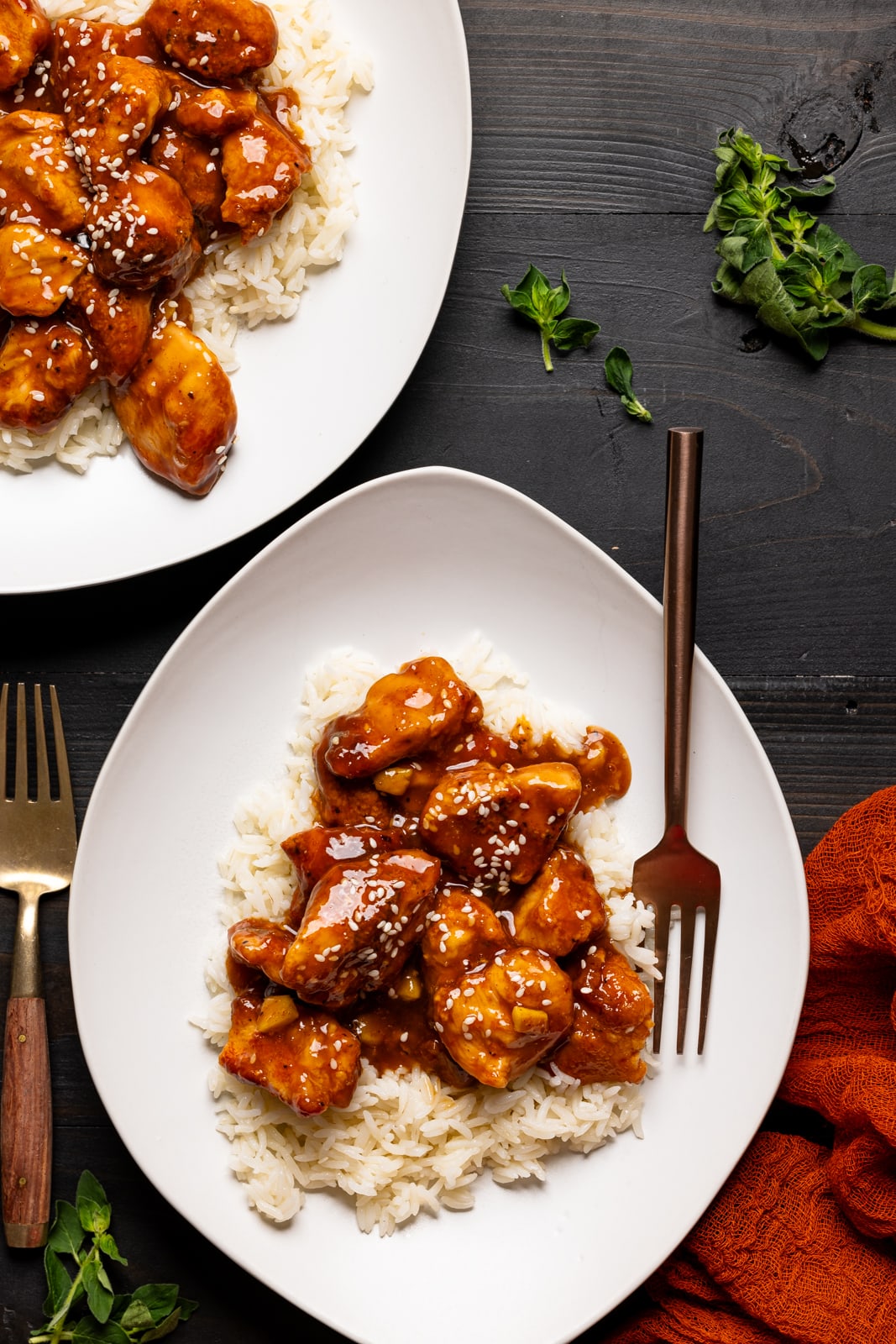 Two plates with chicken and rice with forks. Perfect for a weeknight dinner.