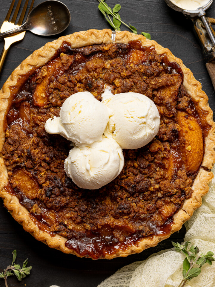 Pie with ice cream scoops and spoons with herbs.