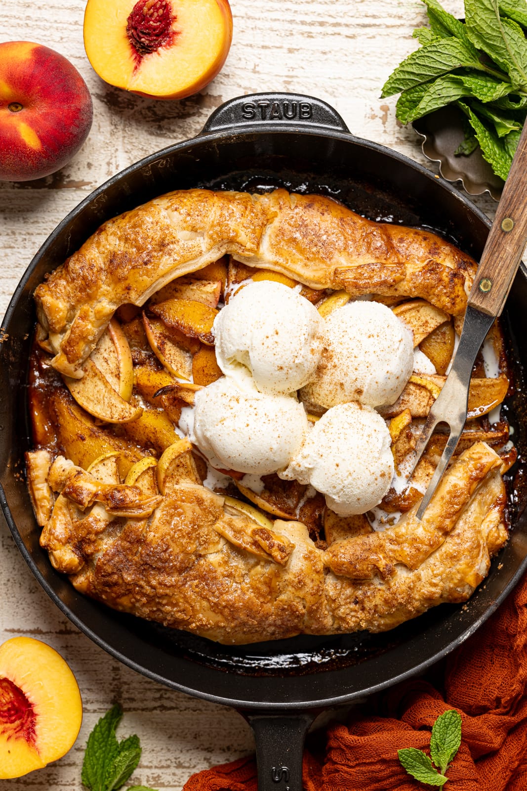Easy Galette in a black skillet with a fork and scoops of ice cream.