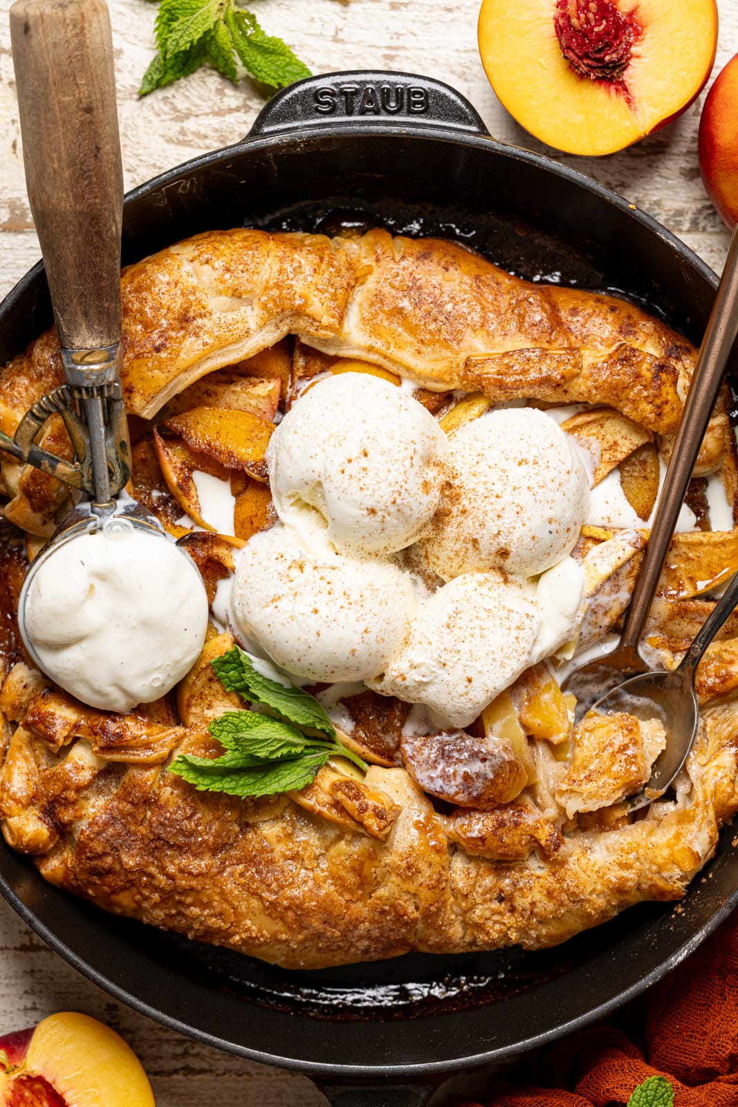 Up close shot of galette with puff pastry + ice cream and a spoon with a scoop. 