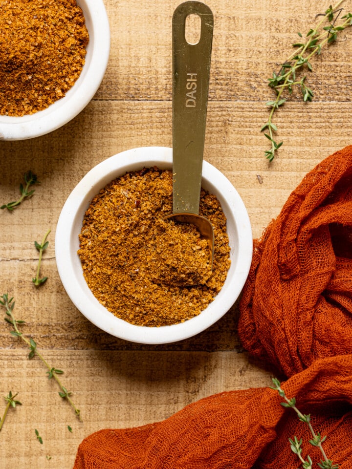 Up close shot of seasoning in a white bowl with spoon.