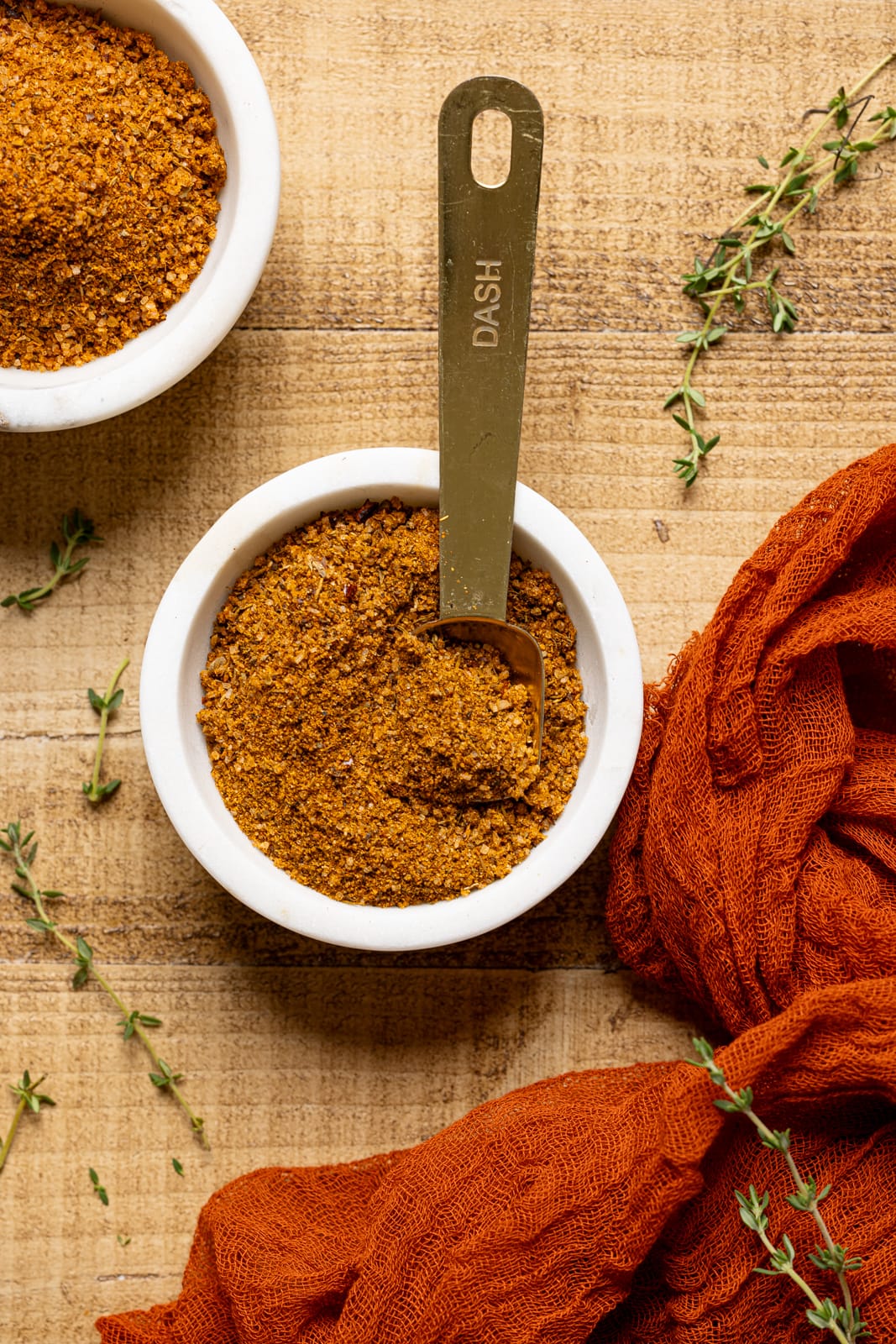 Up close shot of seasoning in a white bowl with spoon.