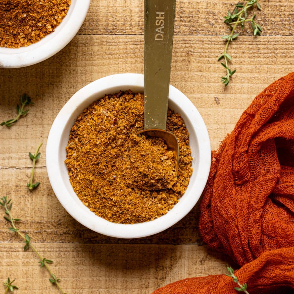 Up close shot of seasoning in a white bowl with spoon.