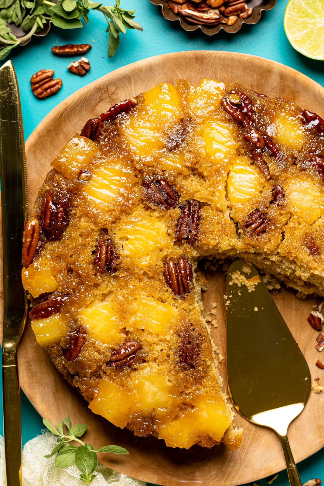 Up close view of the fruity dessert of pineapple cake with a slice removed.