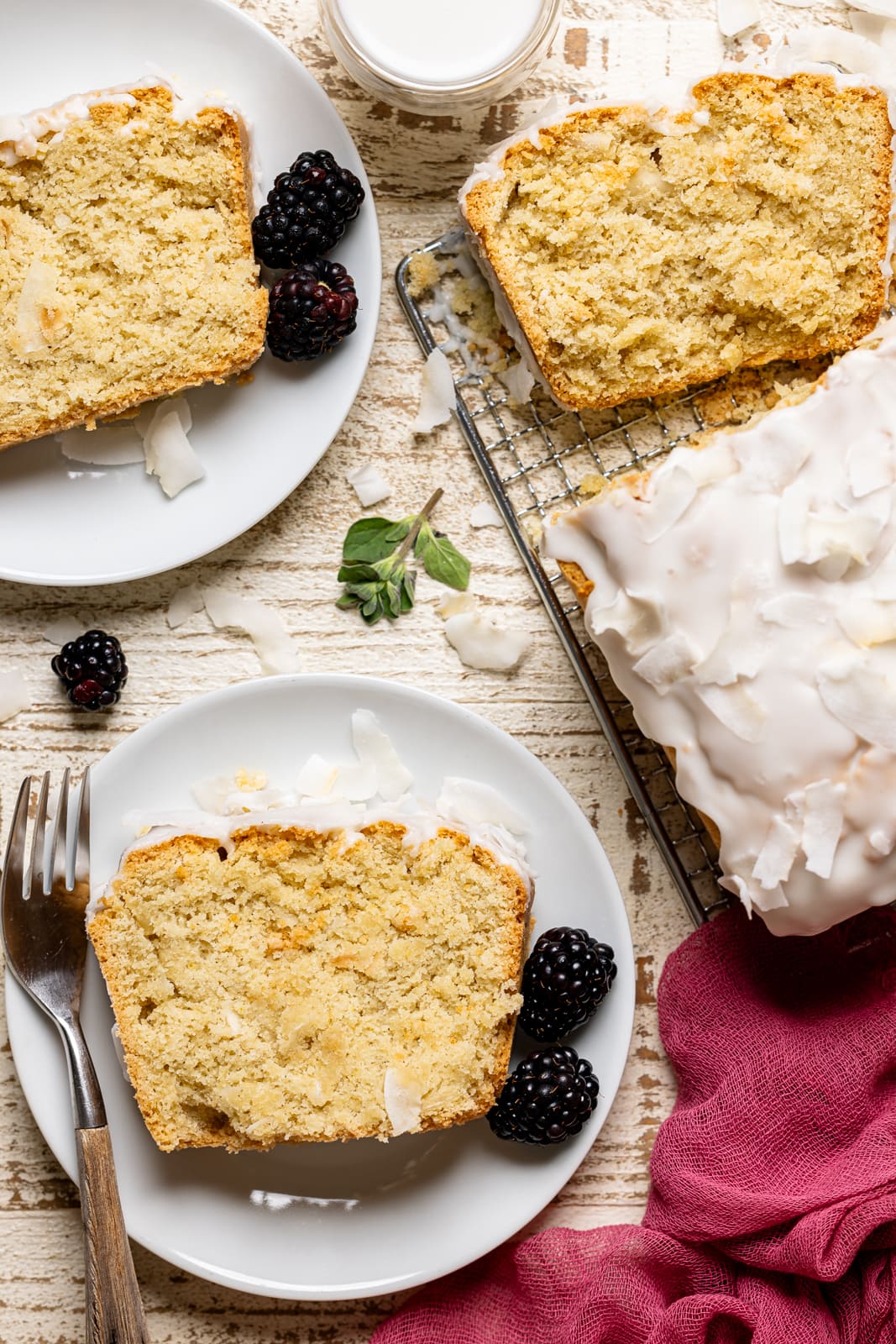 Slices of coconut bread in plates with a fork. 