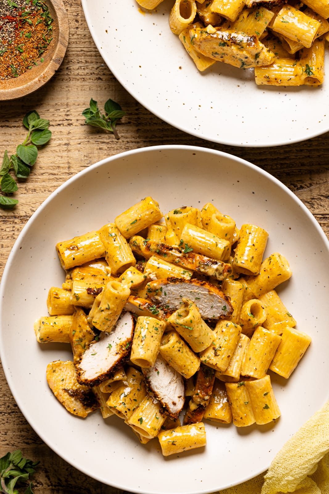 Chicken Pasta Dish on two plates with herbs. 