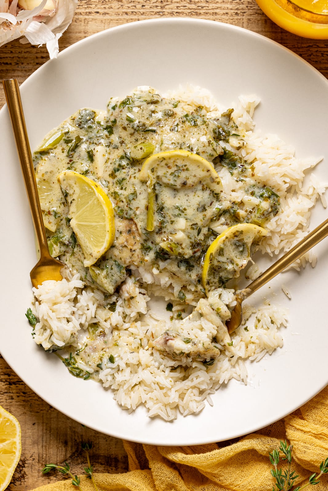 Salmon and rice on a white plate with two forks. 