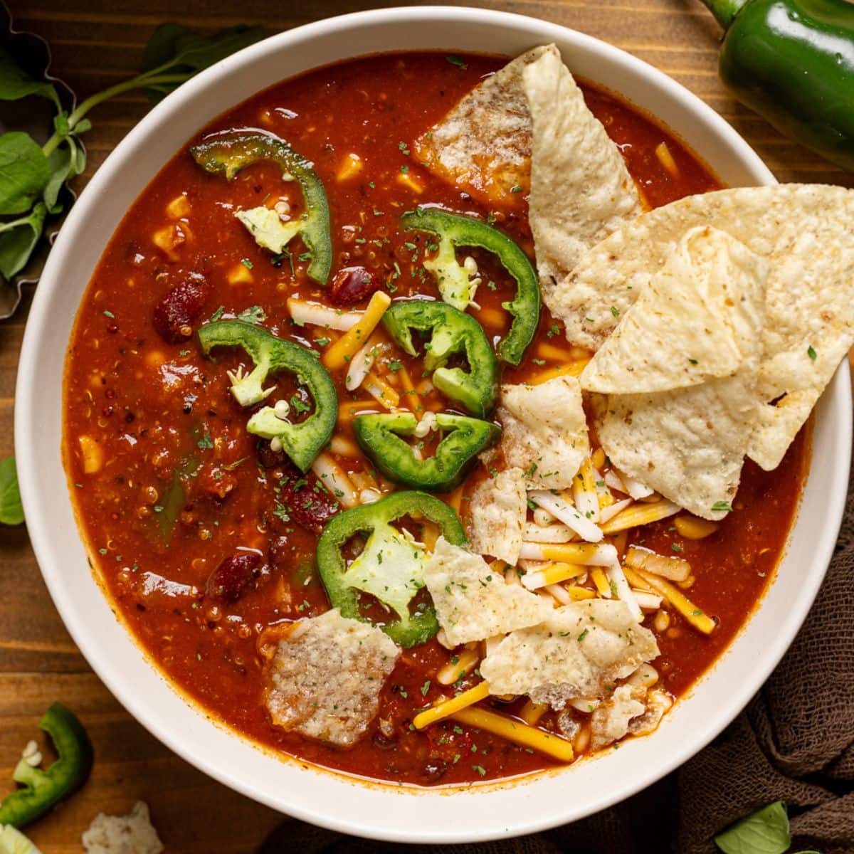 Up close shot of bowl of soup with tortilla chips and jalapeños.