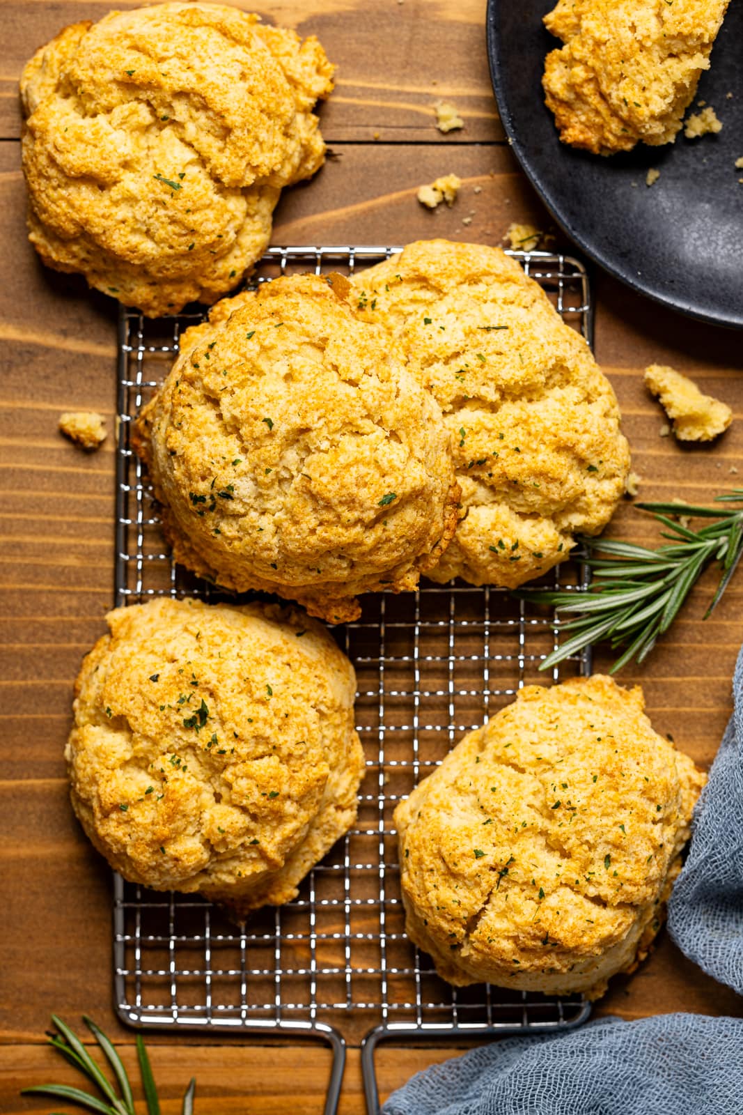 Biscuits on a wire rack on a brown wood table.