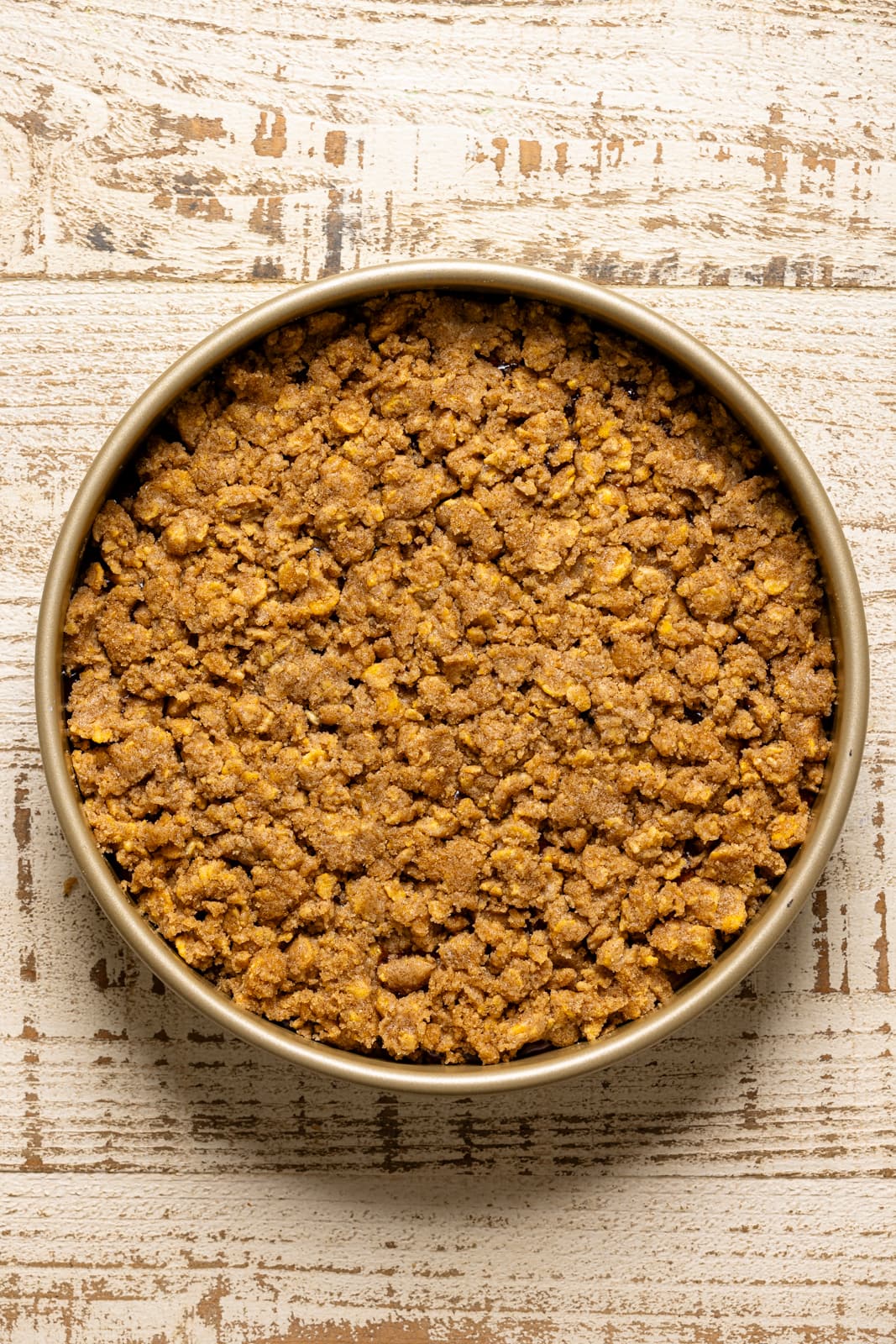 Strawberry Crumb Cake batter and crumble topping in a cake pan.