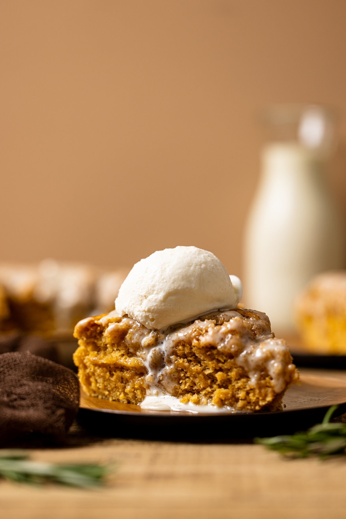 Sliced sweet potato cake with a scoop of ice cream on top.