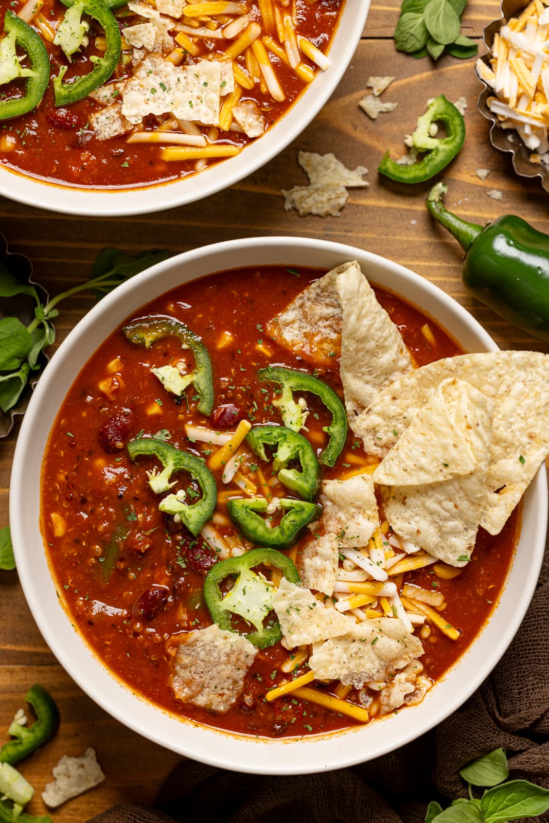 Up close shot of bowl of Vegan taco soup with tortilla chips and jalapeños. 