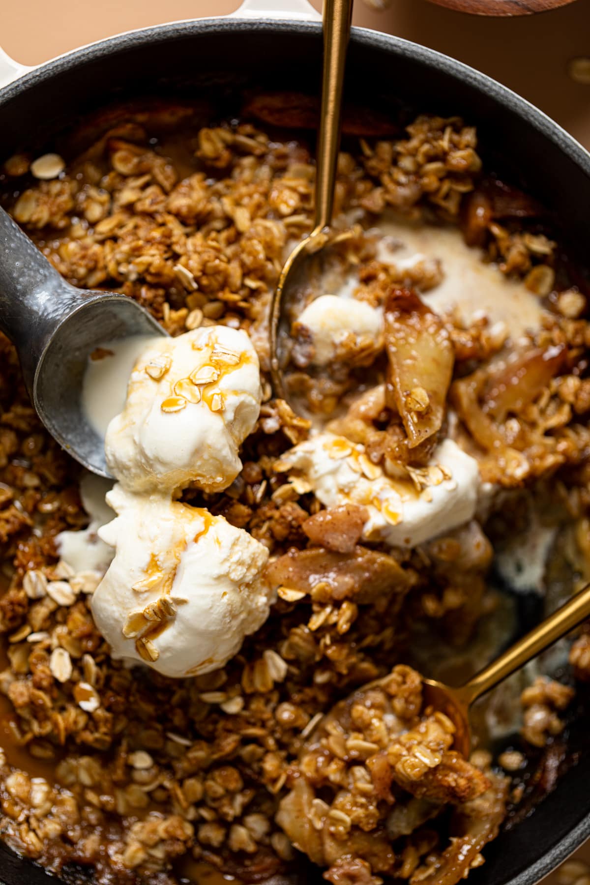 Up close shot of crisp with two spoons, ice creams coop and ice cream.