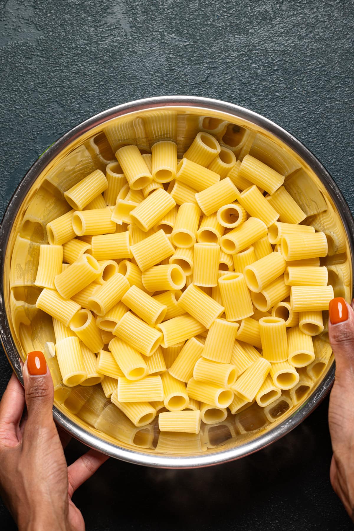 Cooked pasta in a silver bowl.