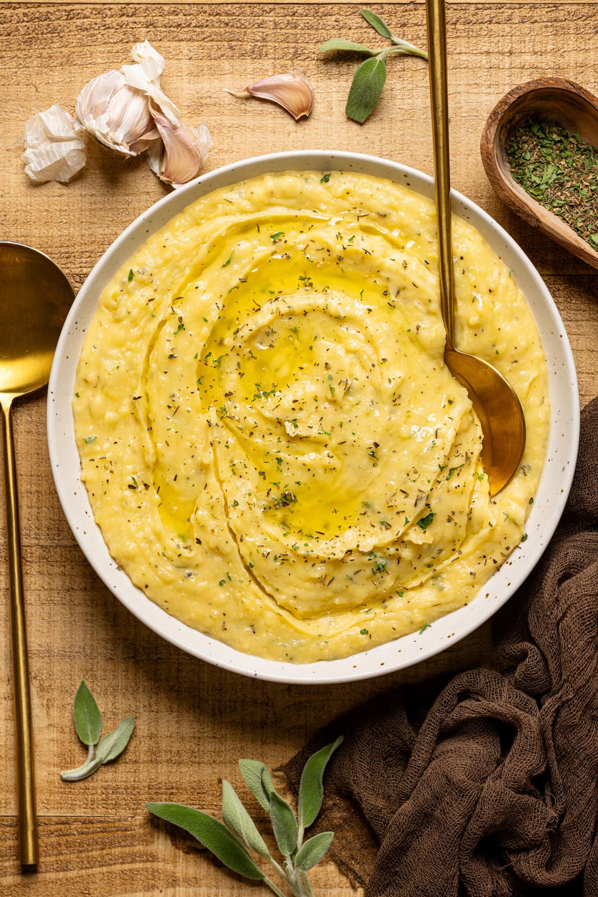 Mashed potatoes in a bowl with two gold spoons.