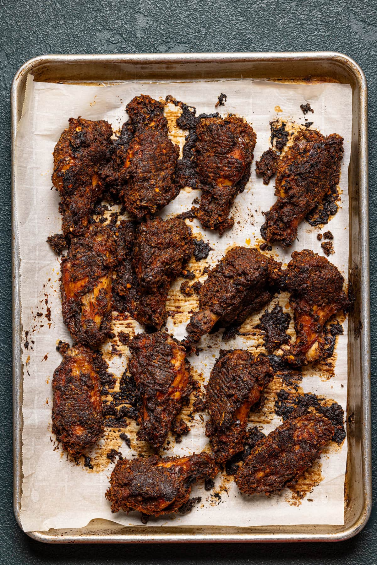 Chicken wings on baking sheet with parchment paper. 