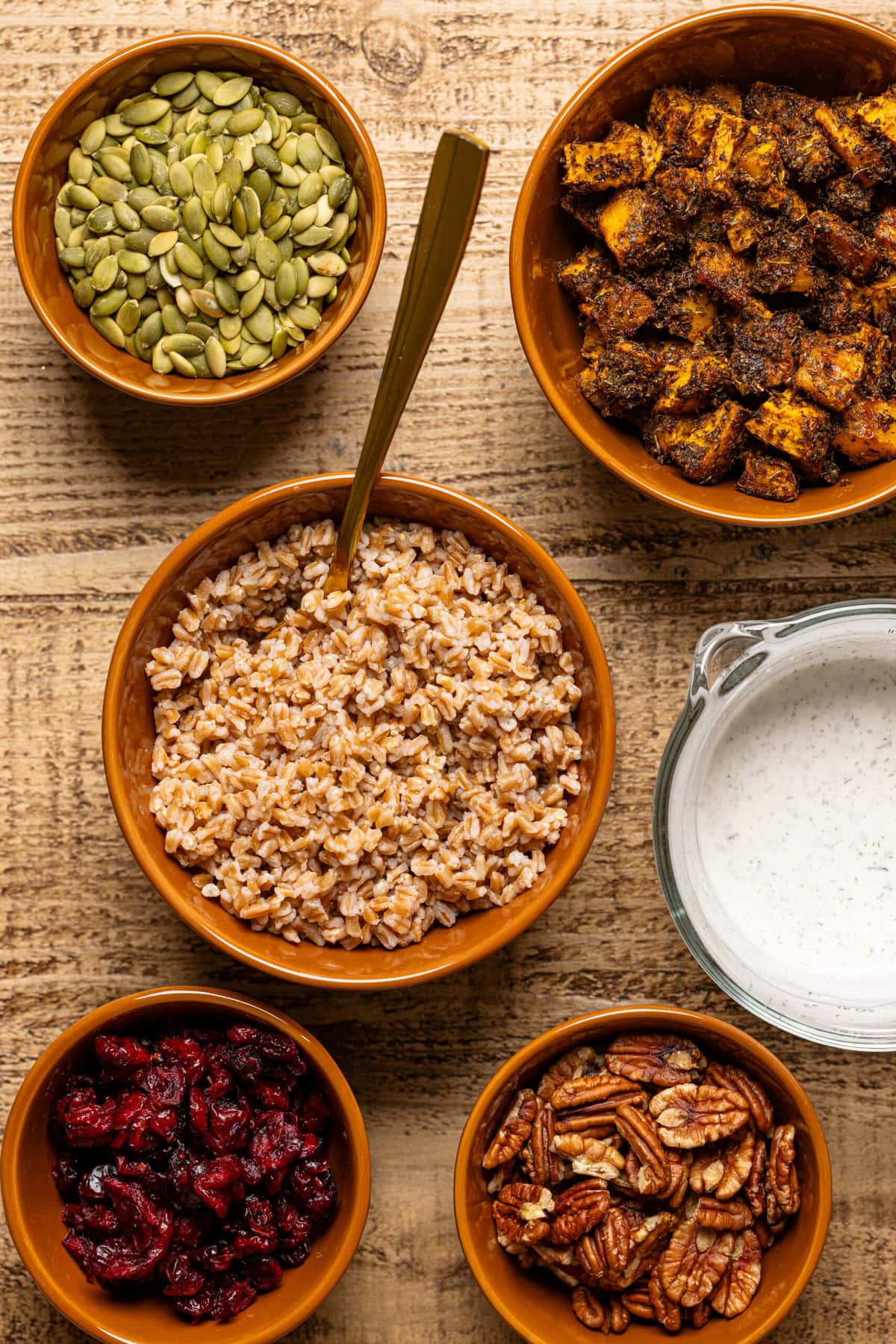 Ingredients on a brown wood table in bowls. 