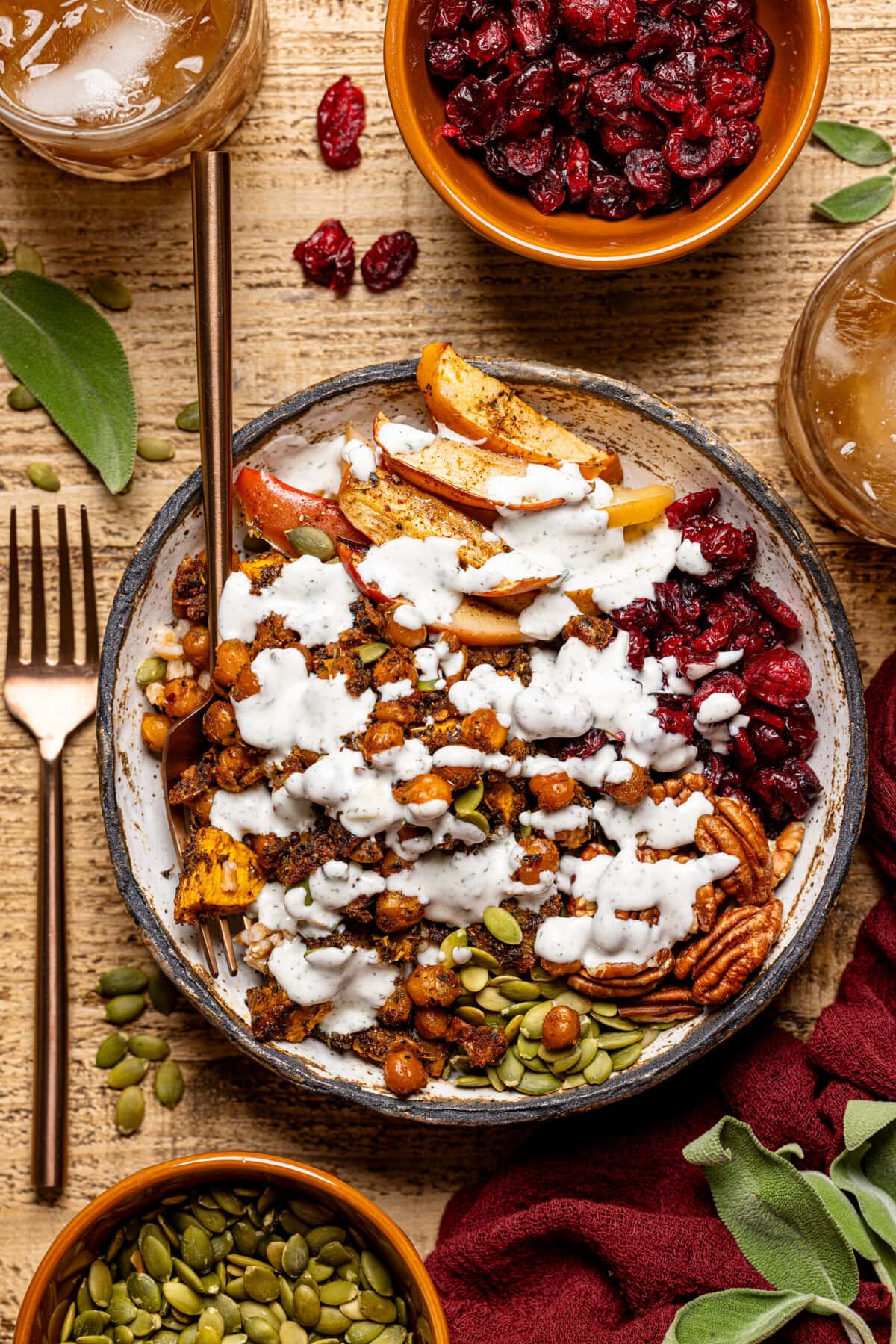 Food bowl with two forks topped with dressing. 