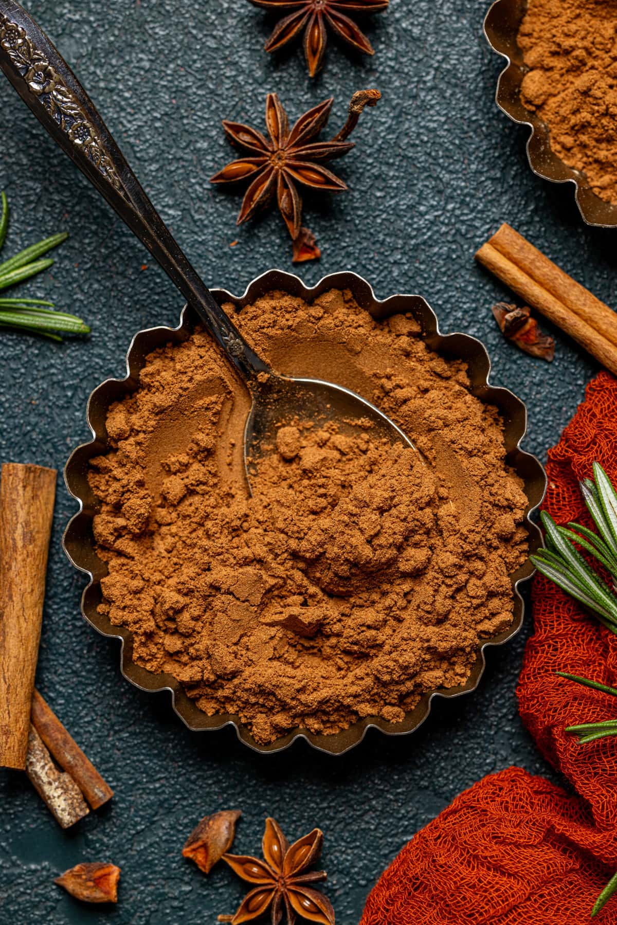 Up close shot of pumpkin spice in a tin with a spoon.