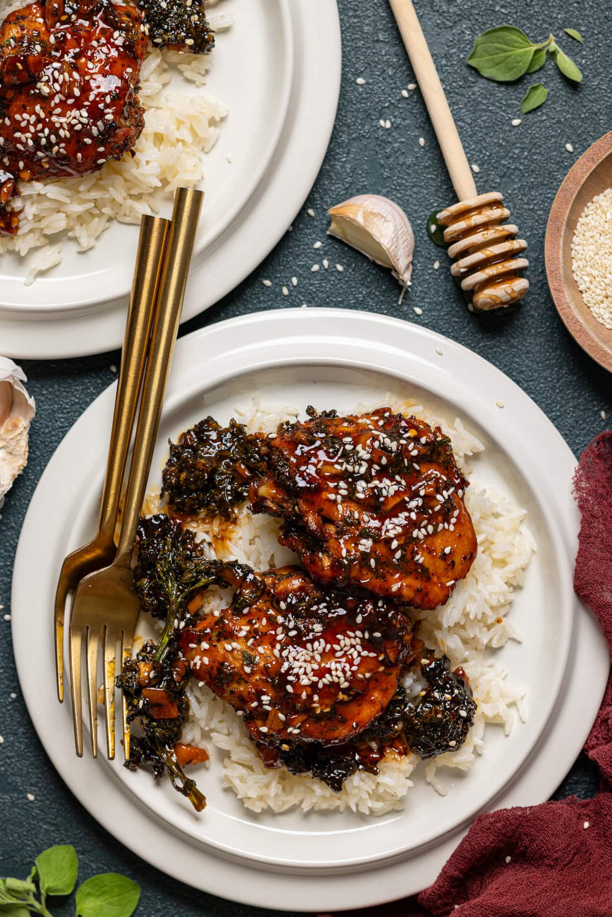 Baked chicken with rice on a white plate with two forks. 