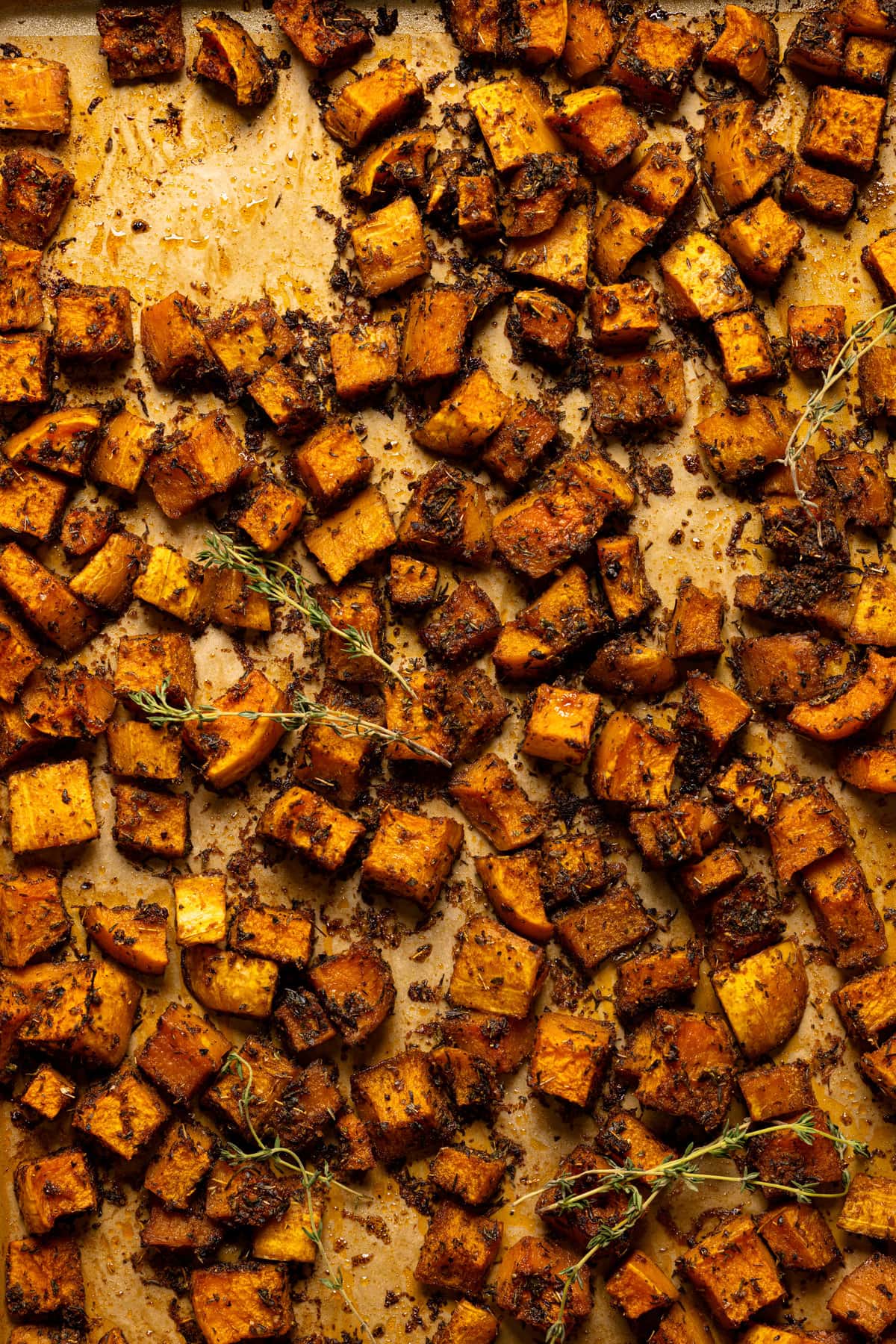 Up close overhead shot of roasted butternut squash in baking sheet.