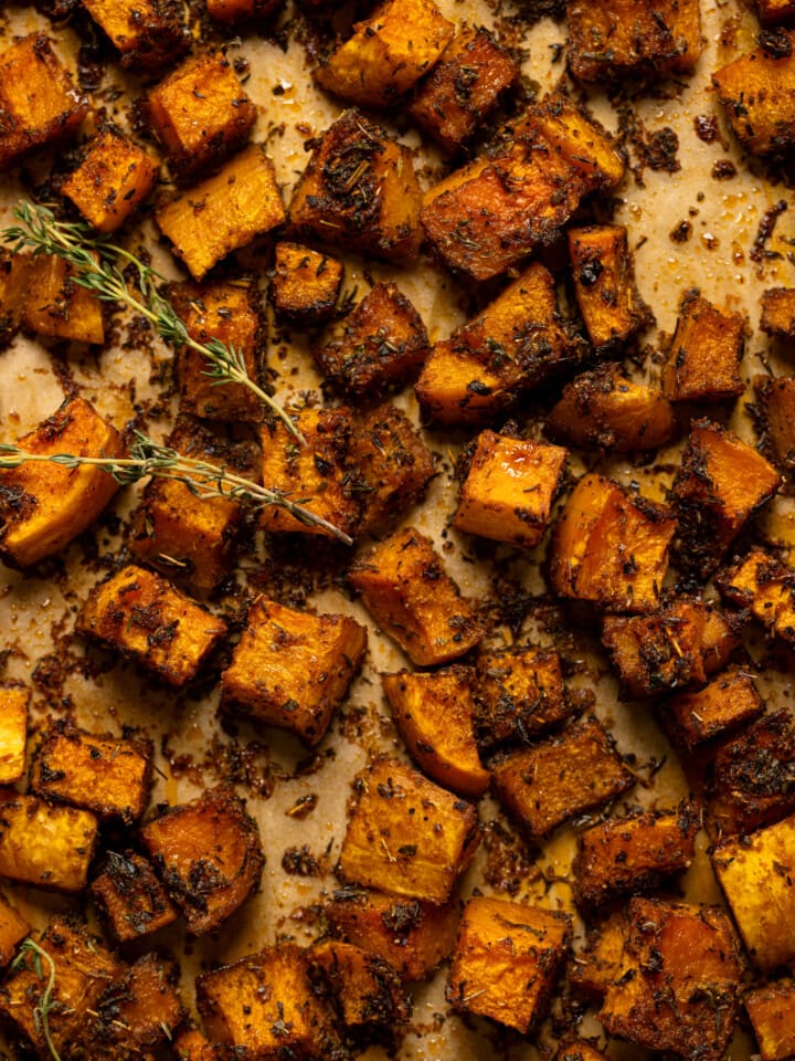 Up close overhead shot of roasted butternut squash in baking sheet.