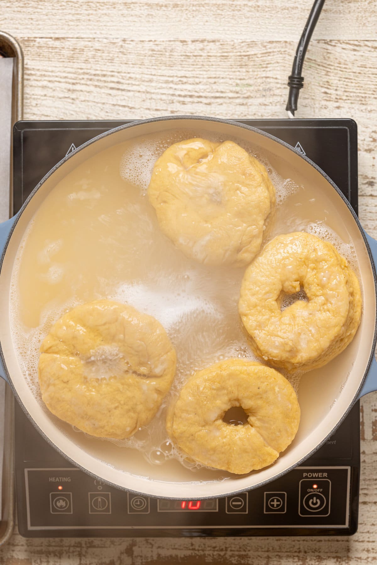 Dough in a honey bath in a pot.