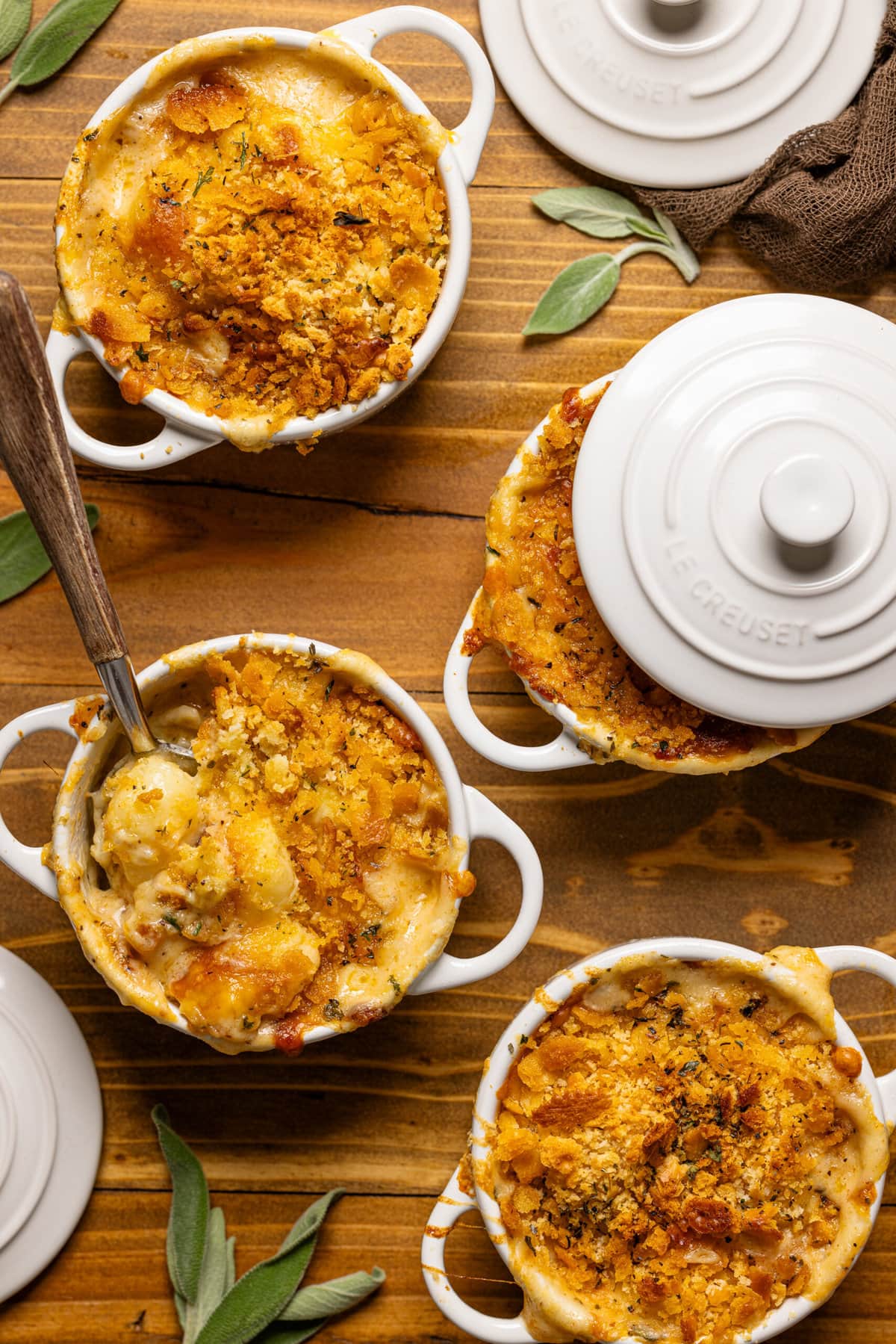 Baked gnocchi in mini cocottes with a spoon.