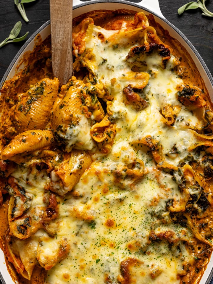 Up close shot of baked shells in a baking dish.