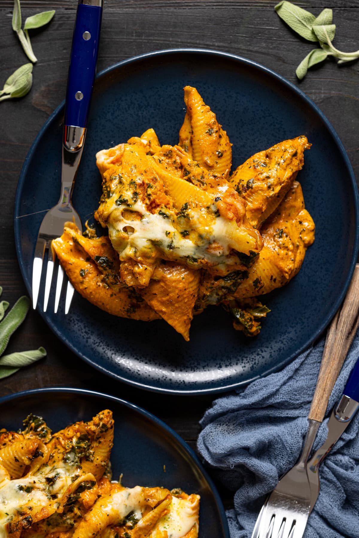 Stuffed shells in a blue plate with a fork.