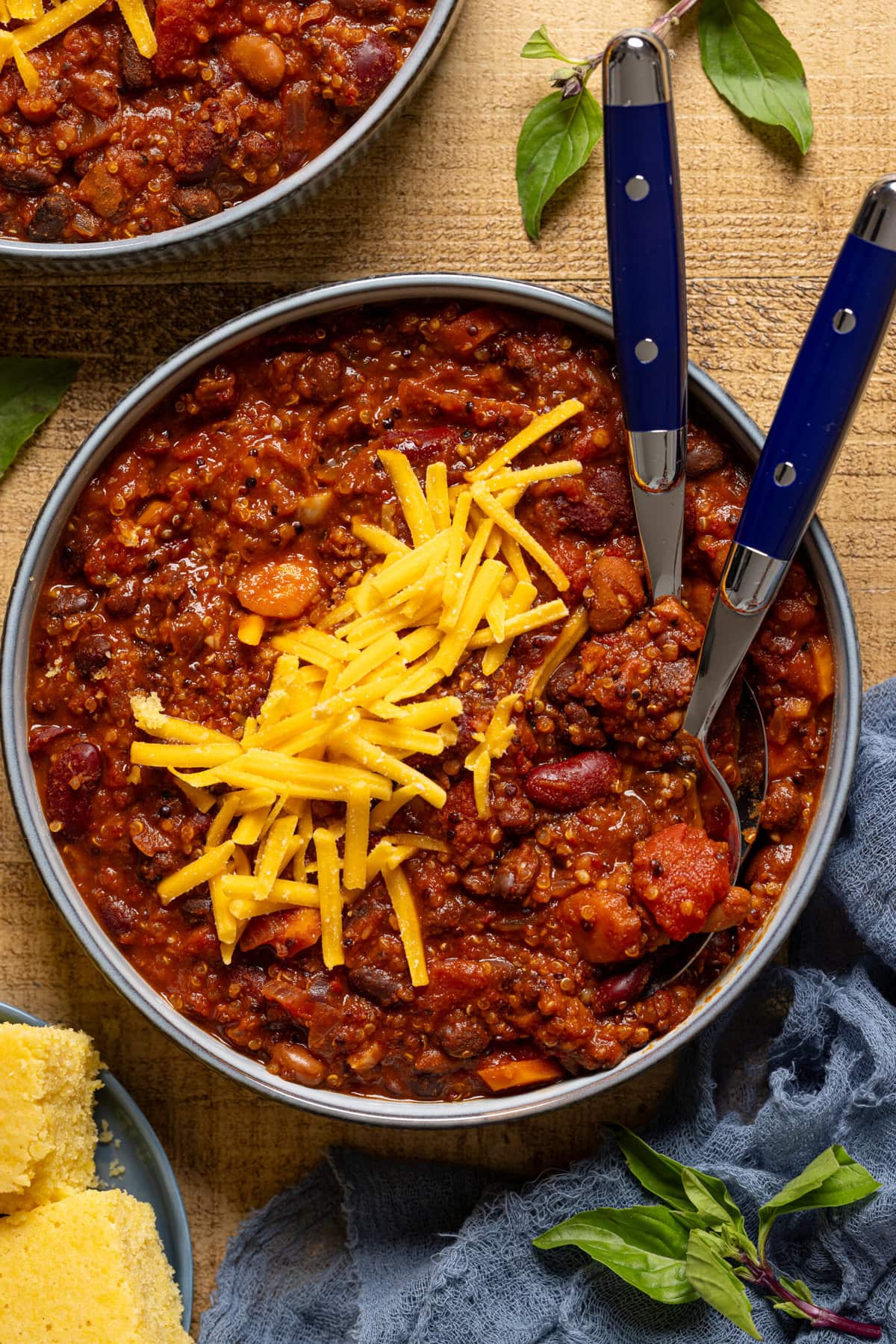 Bowl of chili recipe with two spoons.