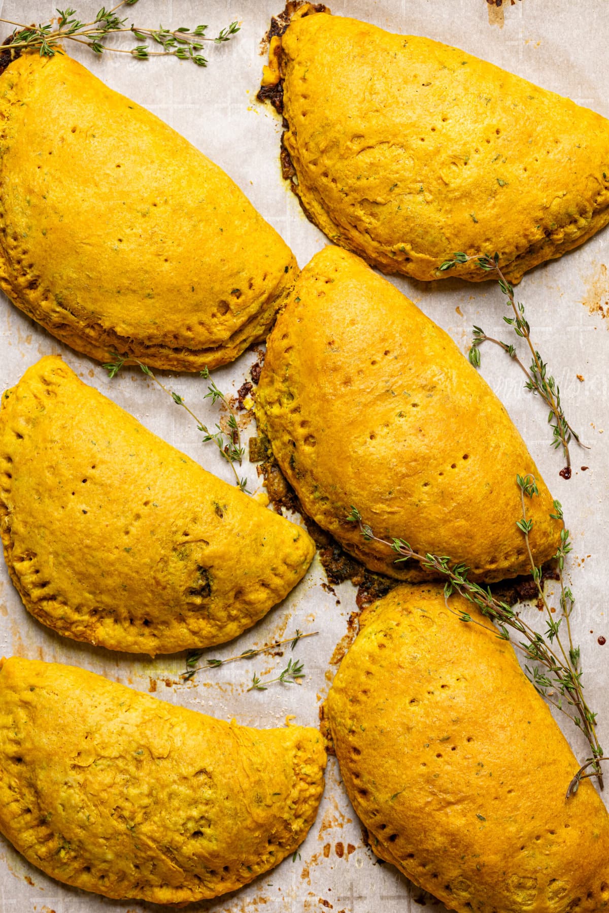 Baked patties on a baking sheet with parchment paper.