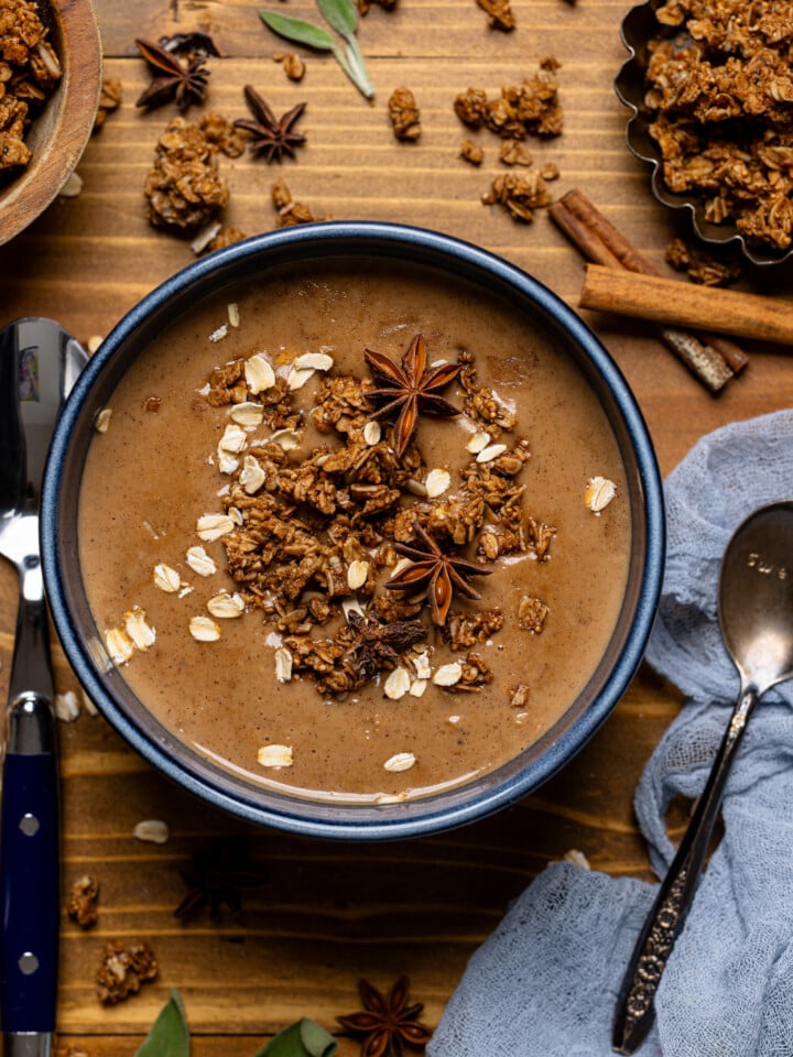 Bowl of oatmeal with spoons and spices.